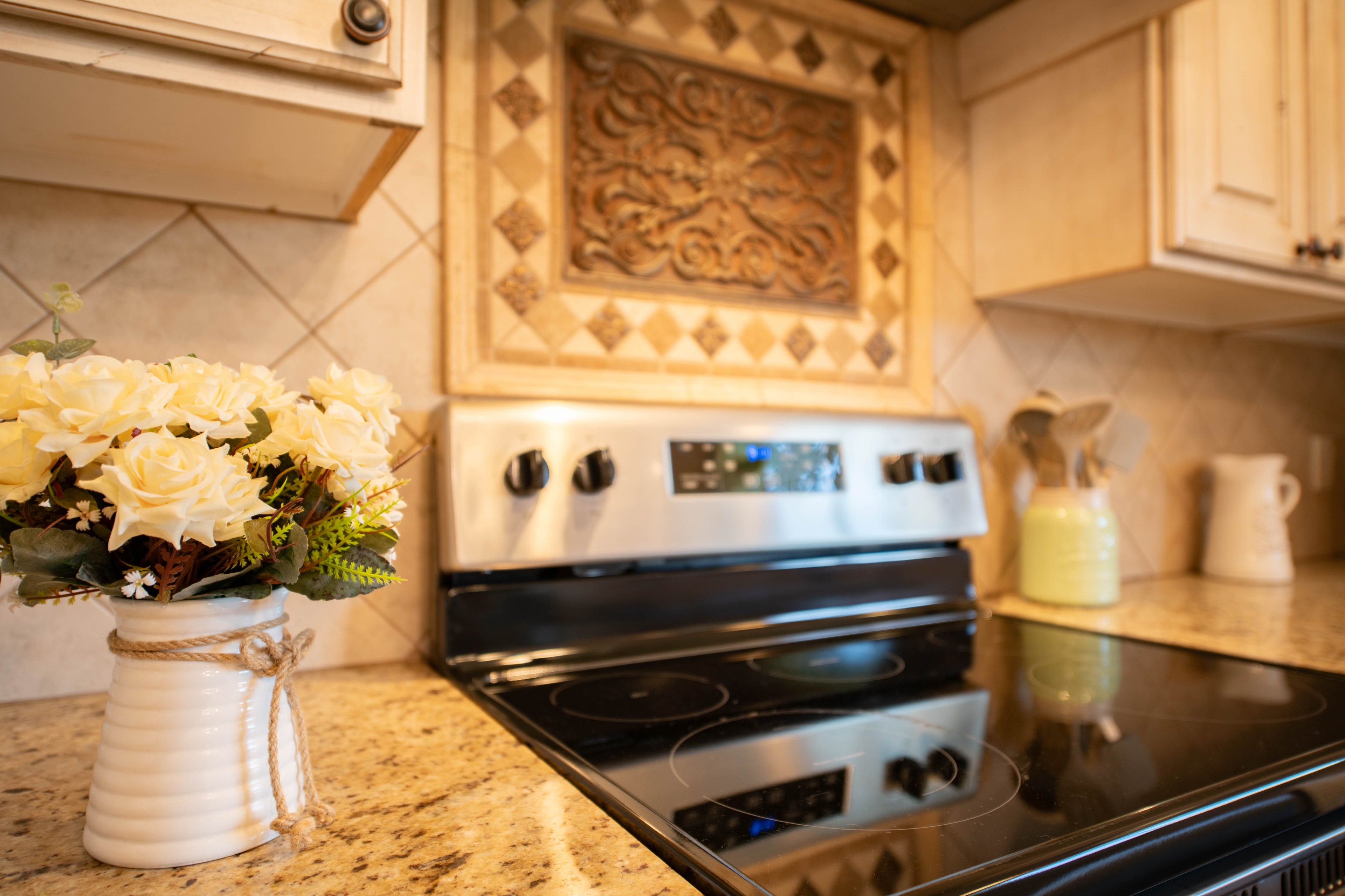 Kanab Airbnb vacation rental kitchen photography — stove detail with yellow roses