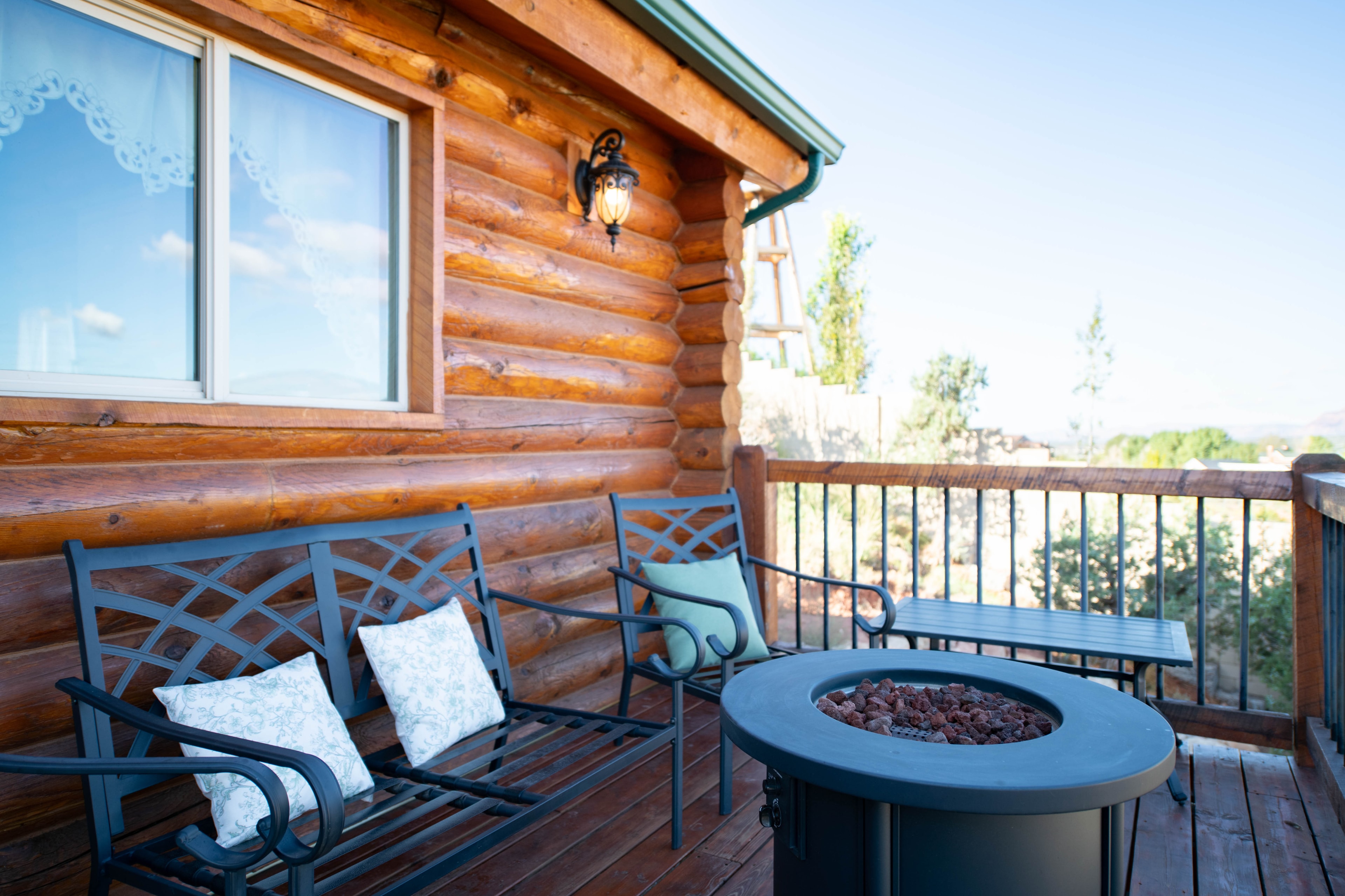 Log cabin deck with fire pit seating — Kanab vacation rental photography