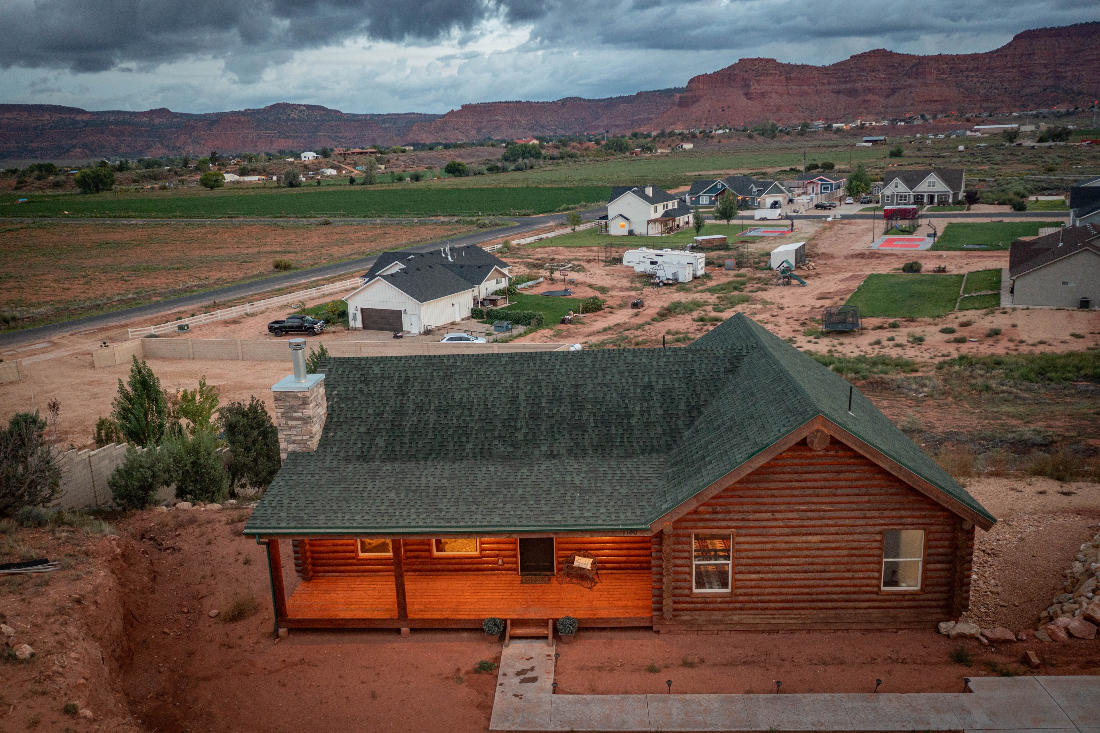 Aerial drone — log cabin subdivision red rock landscape, Kanab Utah