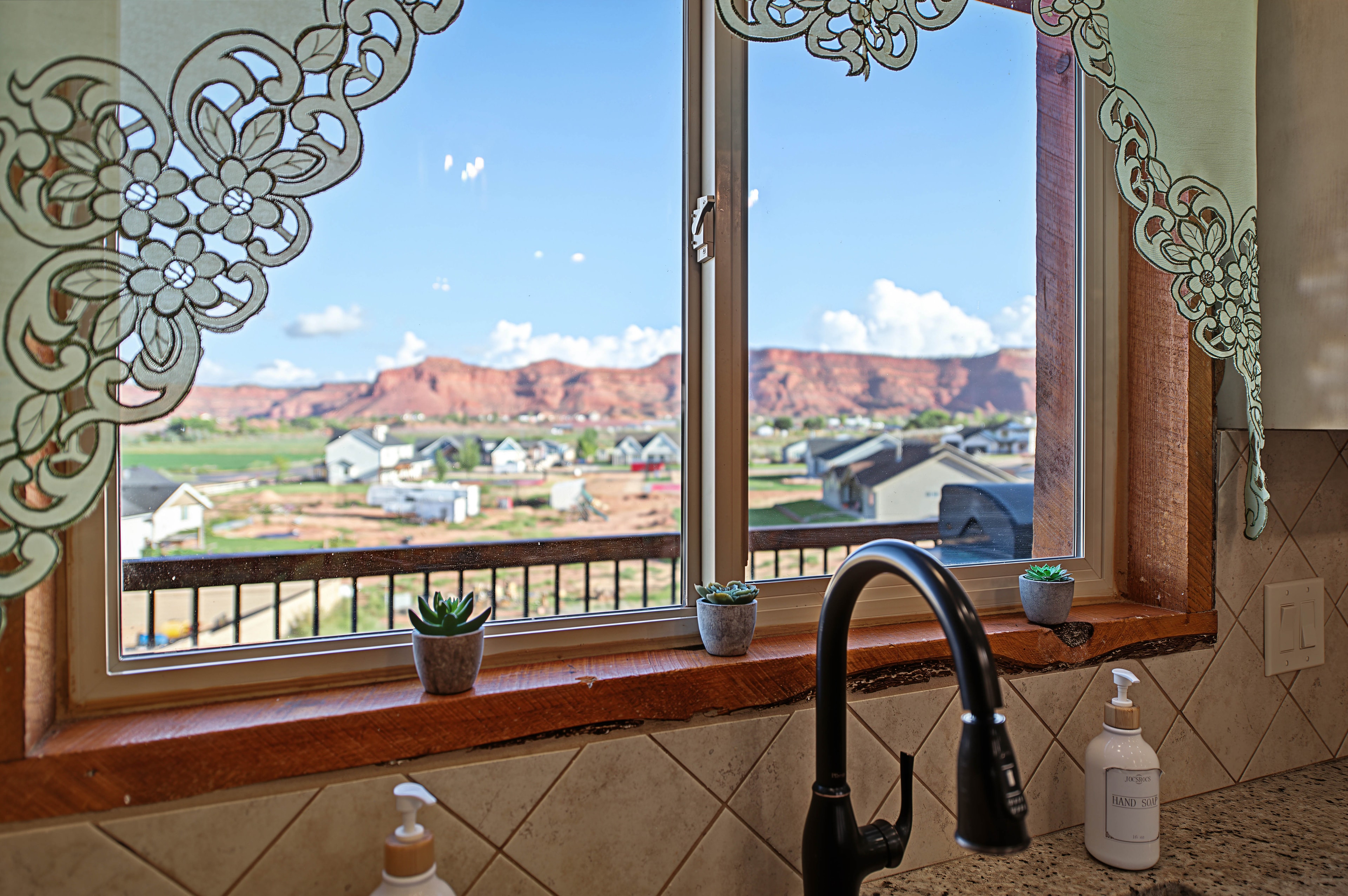Kitchen window with ornate lace and valley view — Kanab vacation rental
