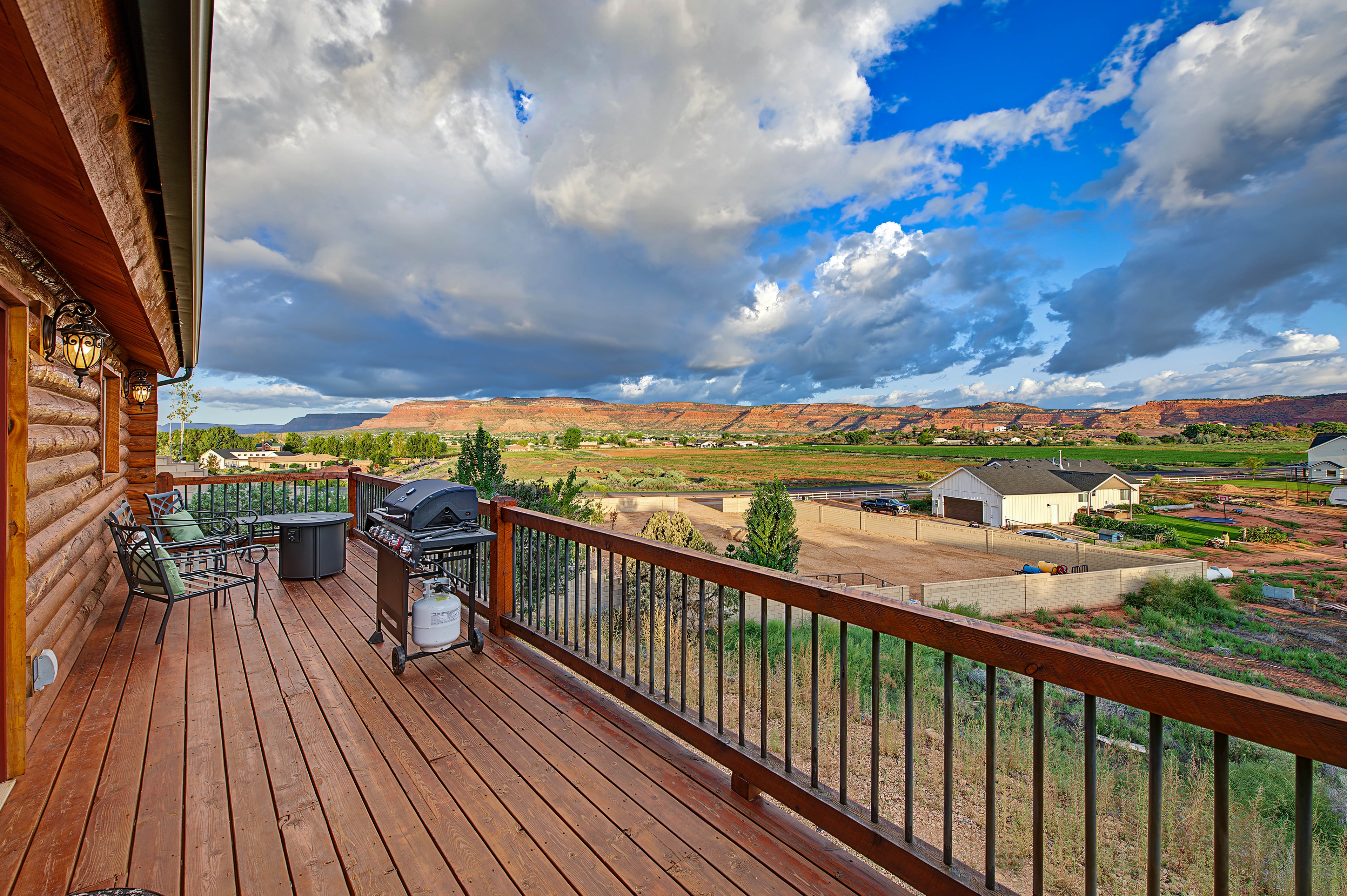Log cabin deck overlooking rural valley — Kanab property photography