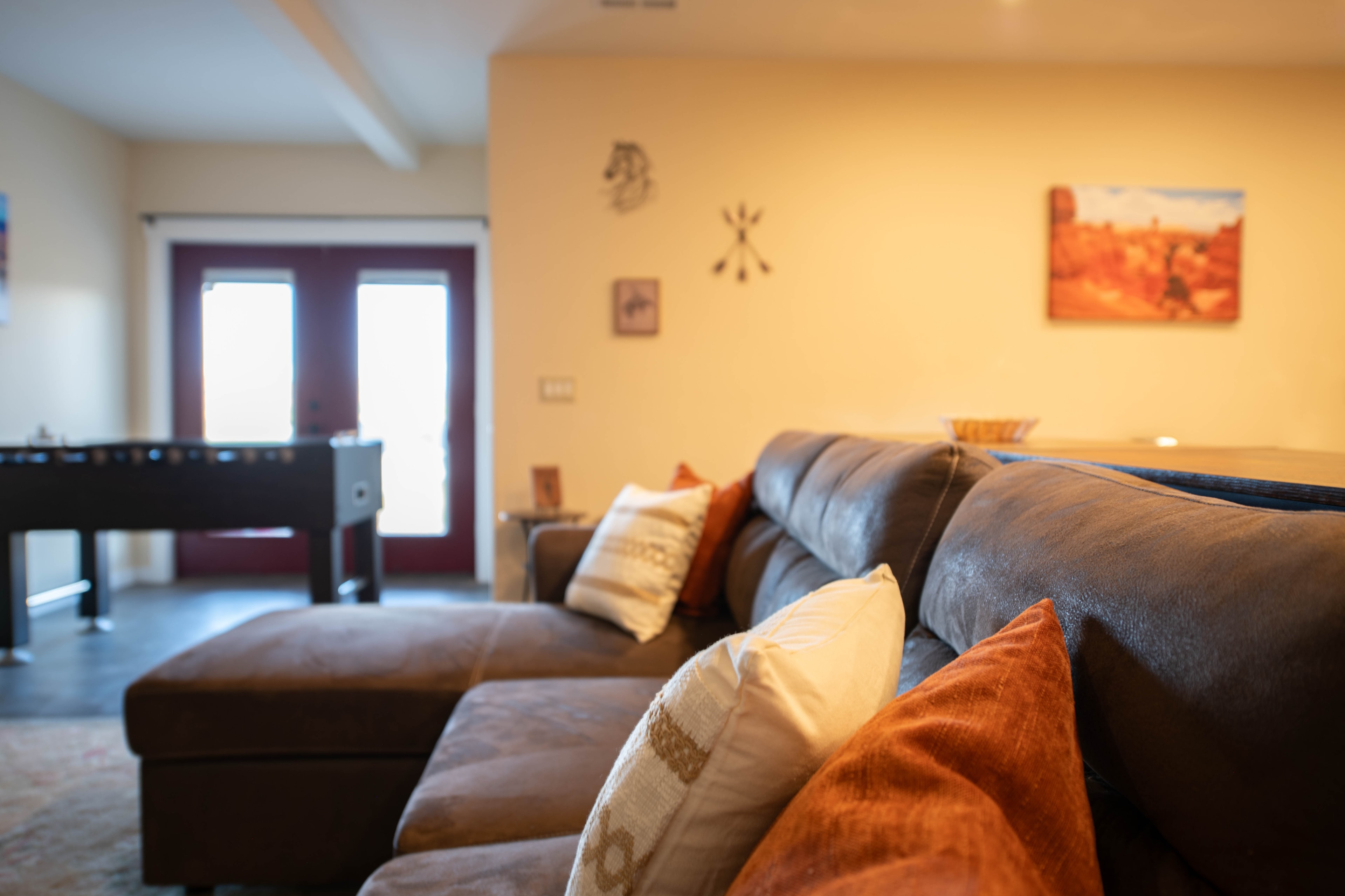 Living room with leather sectional and foosball table — Kanab vacation rental