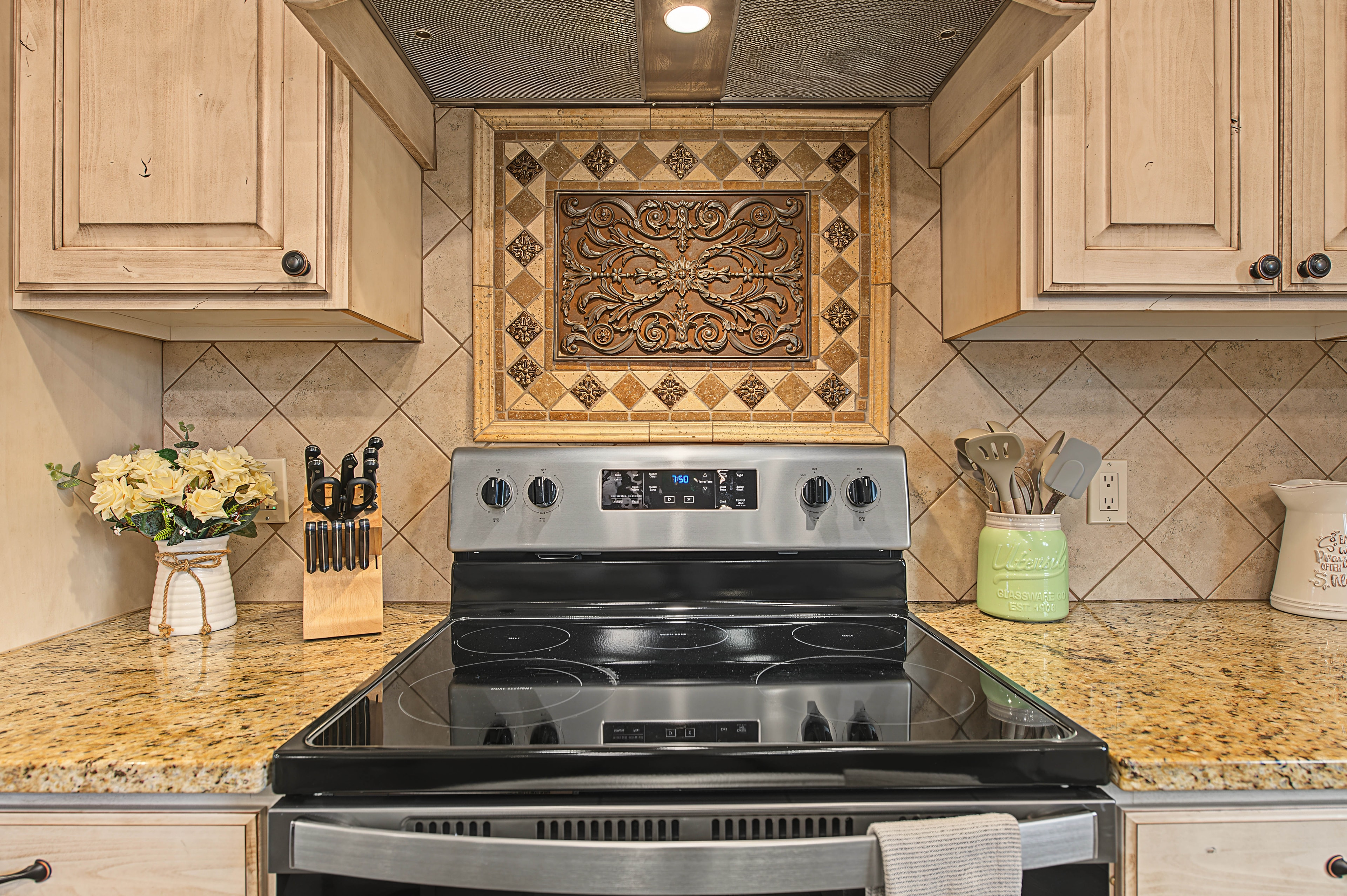Elegant kitchen with ornate backsplash tile — Kanab vacation rental interior